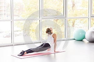 Woman doing yoga, cobra pose, Bhujaá¹…gÄsana posture